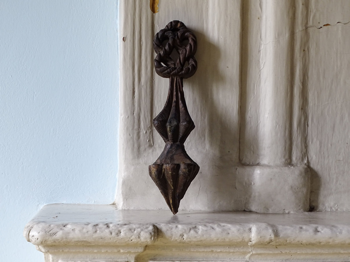 French antique wooden candle sconce, pictured on a country fireplace mantel