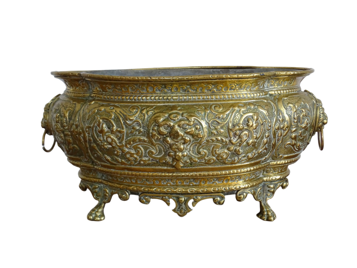 French antique brass jardinière with lion head handles and claw feet
