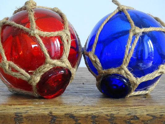 Pair of French vintage glass fishing floats in red and blue glass