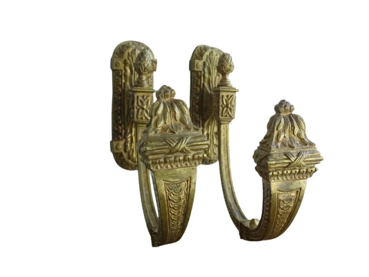 Large pair of French antique curtain hooks in gilt bronze with intricate detailing. Empire style hooks featuring intricate acanthus leaf motifs, acorn finials and architectural elements