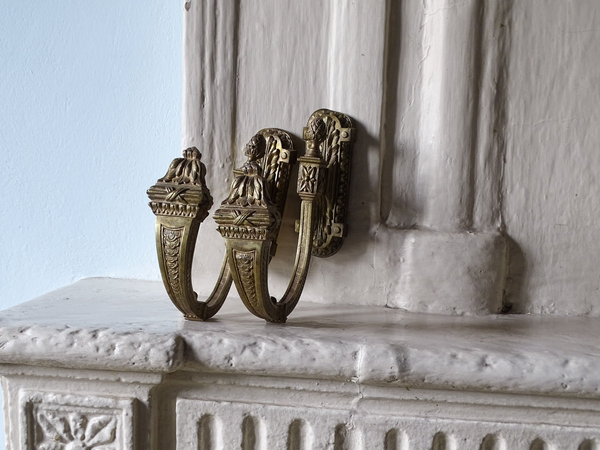 French antique curtain holdbacks in gilt bronze, pictured in a country house setting