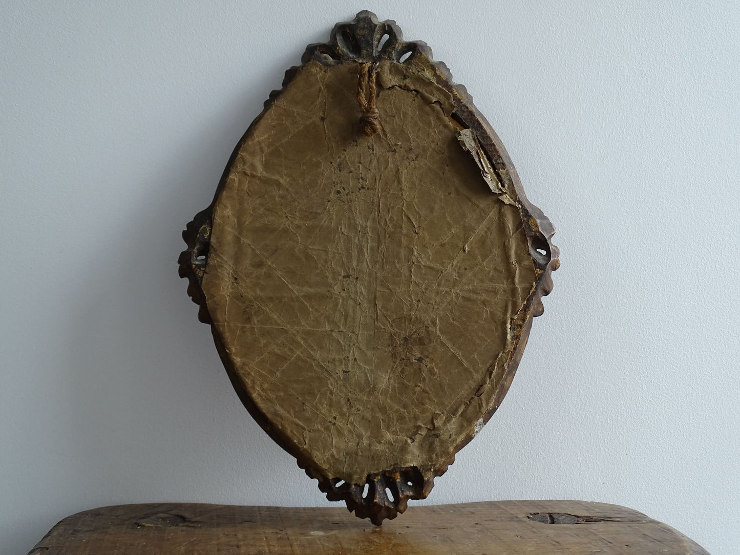 French antique framed crucifix with a gold wood oval frame and a brown velvet background