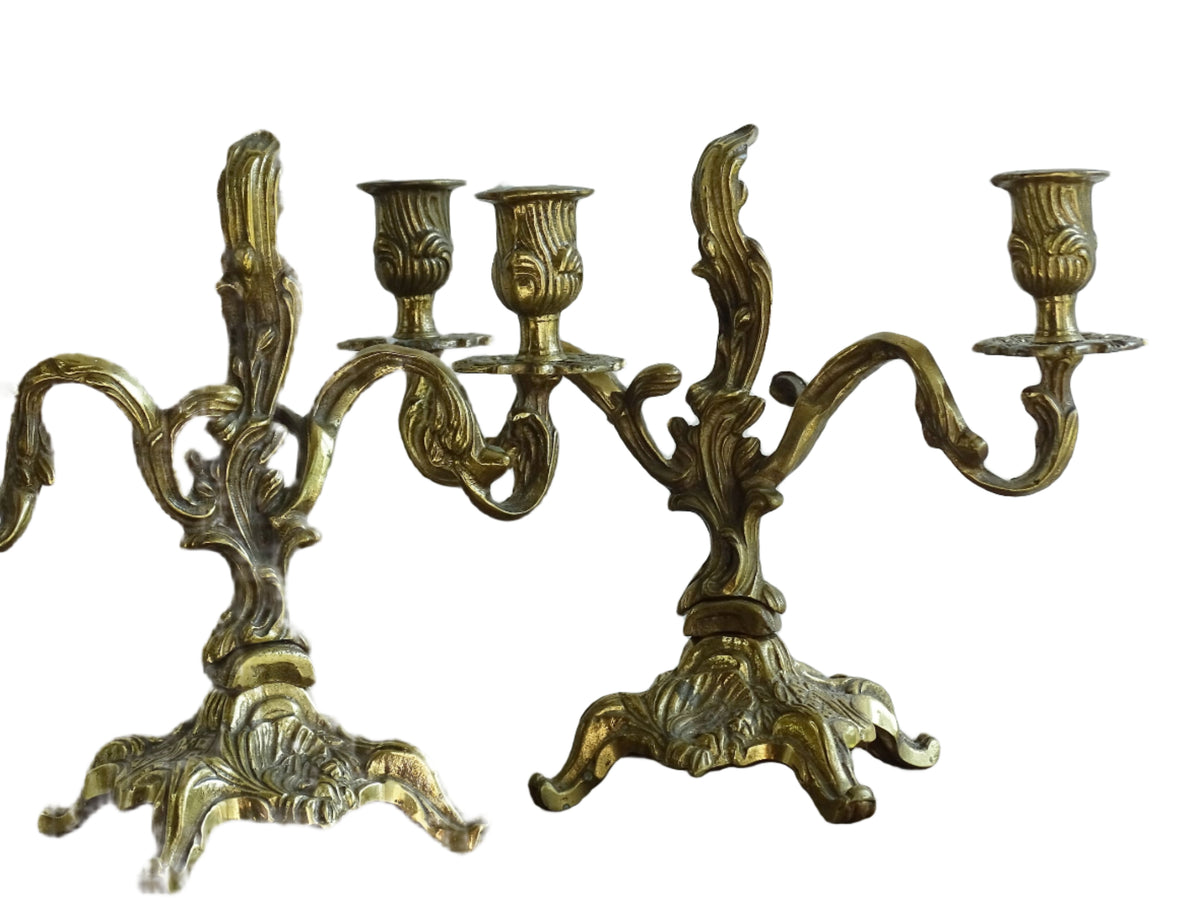 Pair of French antique brass candelabras in a rococo style. Early 20th century antique candelabras with space for two tapered candlesticks. Brass candle holders for dining table decor or living room decor.