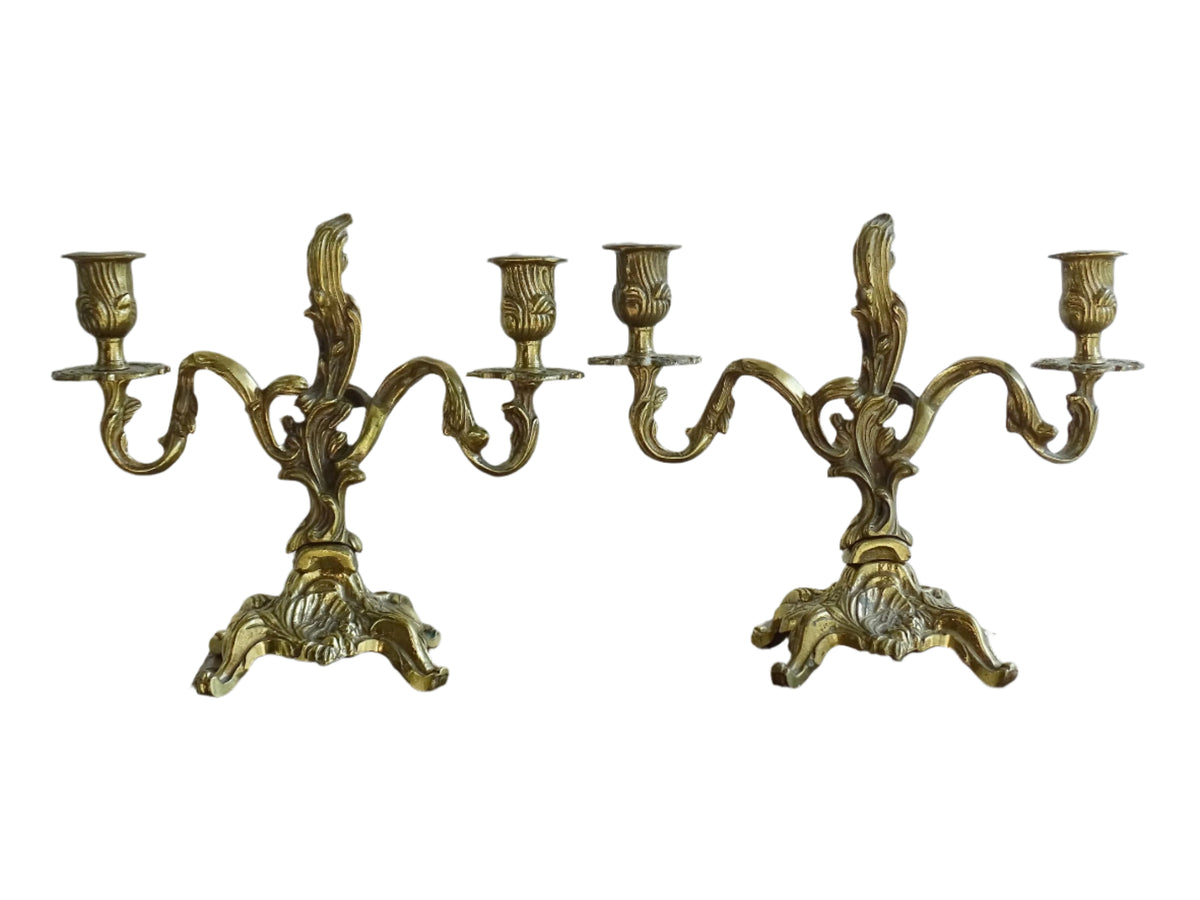 Pair of French antique brass candelabras in a rococo style. Early 20th century antique candelabras with space for two tapered candlesticks. Brass candle holders for dining table decor or living room decor.