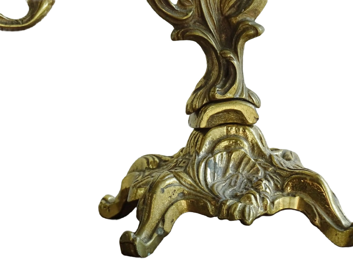 Pair of French antique brass candelabras in a rococo style. Early 20th century antique candelabras with space for two tapered candlesticks. Brass candle holders for dining table decor or living room decor.