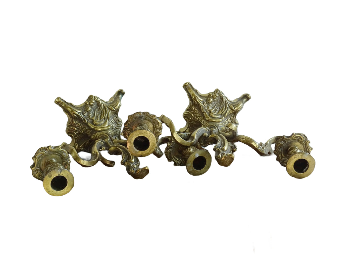 Pair of French antique brass candelabras in a rococo style. Early 20th century antique candelabras with space for two tapered candlesticks. Brass candle holders for dining table decor or living room decor.