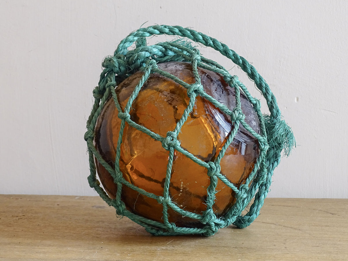 French vintage glass buoy in amber glass with green rope