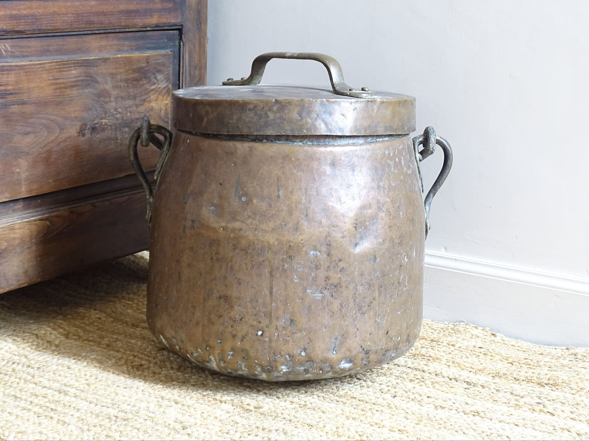Large antique French copper cauldron with wrought iron handle, lid and rounded base. French farmhouse kitchen decor.