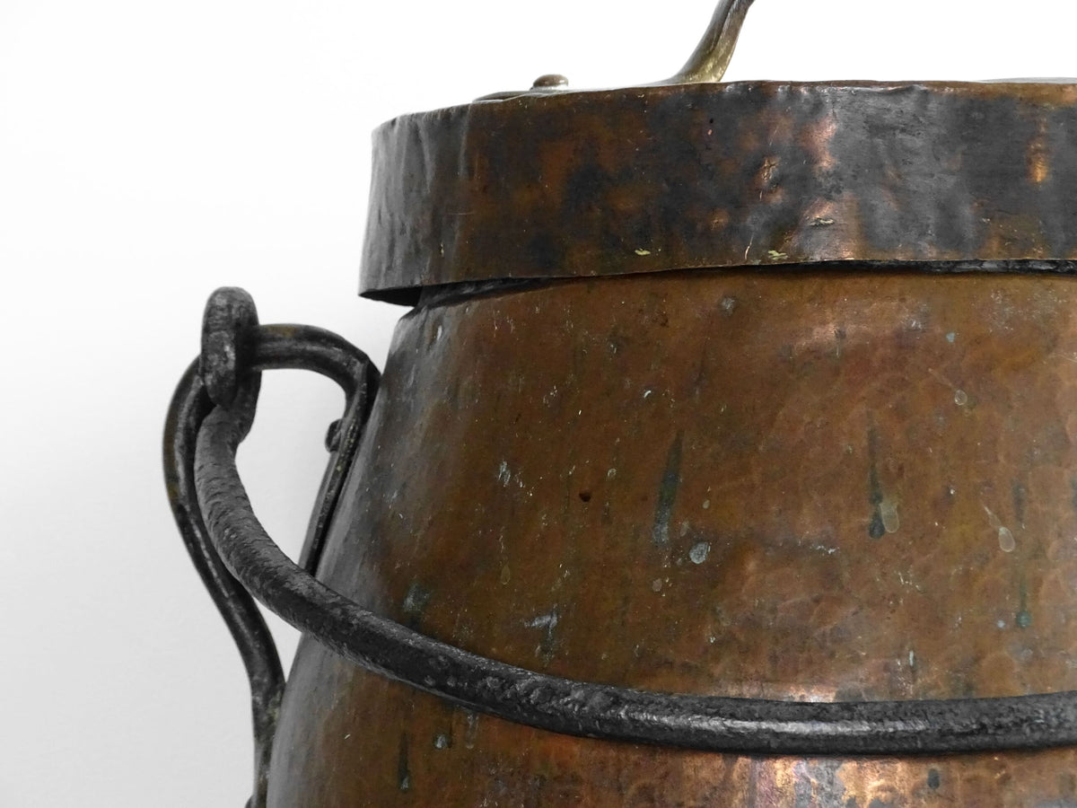 Large antique French copper cauldron with wrought iron handle, lid and rounded base. French farmhouse kitchen decor.