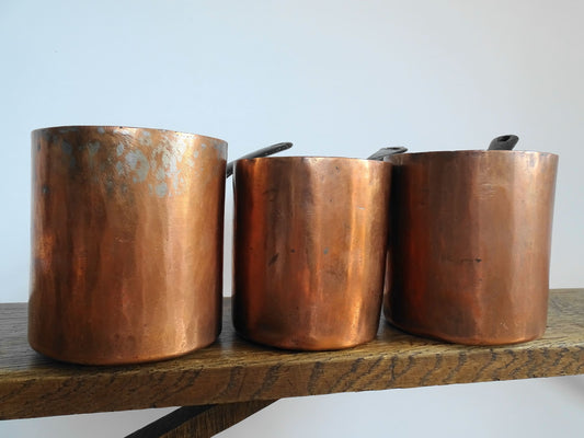 Set of three French antique copper saucepans, antique copper pans with patina