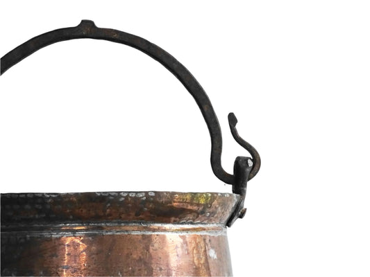 French antique copper cauldron with wrought iron handle. Antique tinned copper pot for fireplace decoration or farmhouse style kitchen decor.
