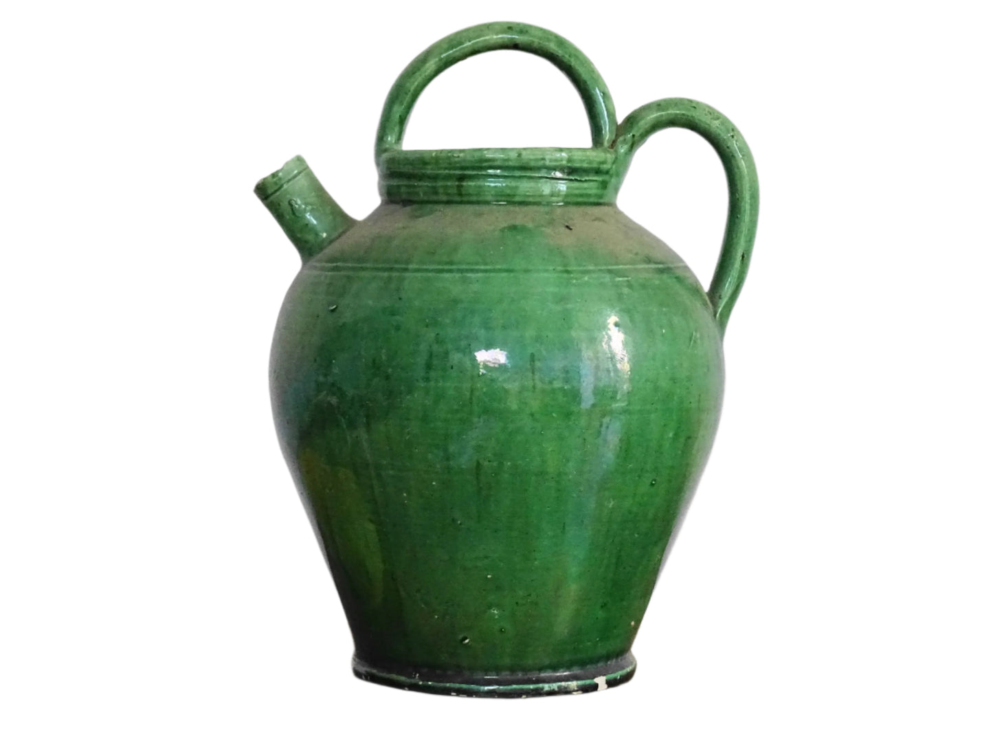 French antique gargoulette with green glaze from Provence. This antique Provençal water pitcher has a spout and two handles with a vivid green glaze. Pottery cruche.