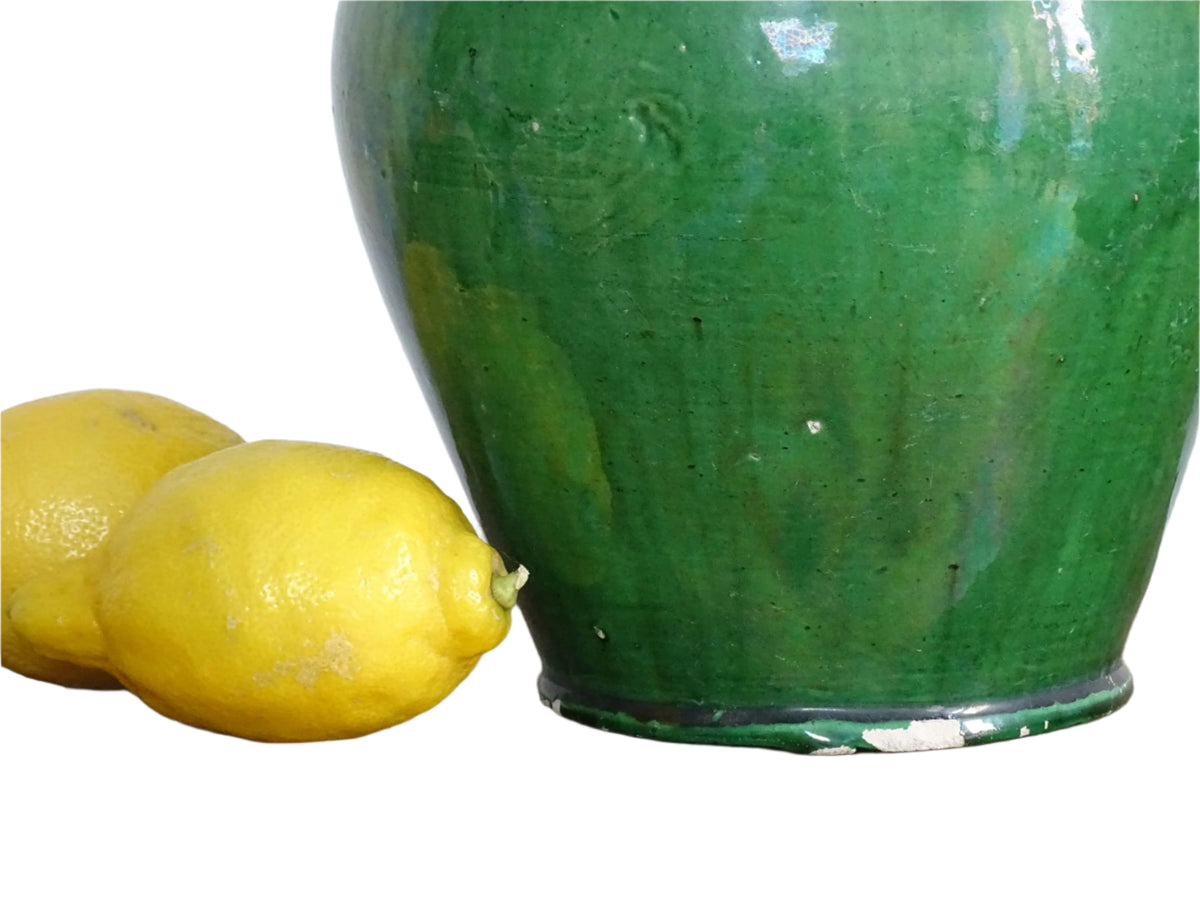 French antique gargoulette with green glaze from Provence. This antique Provençal water pitcher has a spout and two handles with a vivid green glaze. Pottery cruche.