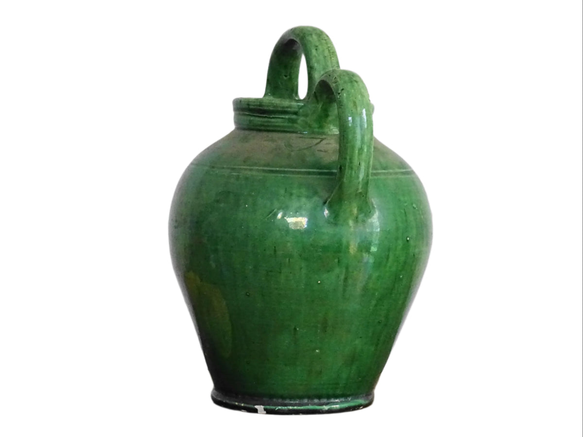 French antique gargoulette with green glaze from Provence. This antique Provençal water pitcher has a spout and two handles with a vivid green glaze. Pottery cruche.