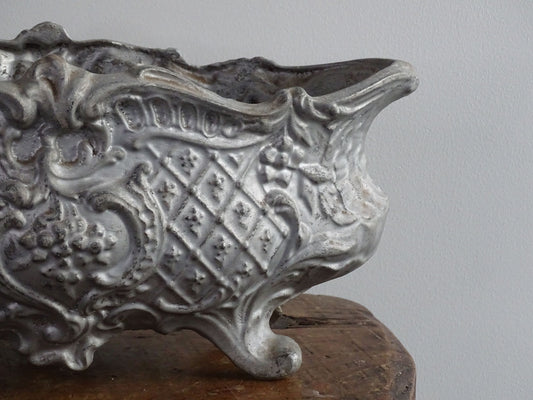 French antique cast iron planter in an oval shape with four ornate feet, painted silver, ideal for indoor or outdoor decor. Antique planter or antique French jardiniere