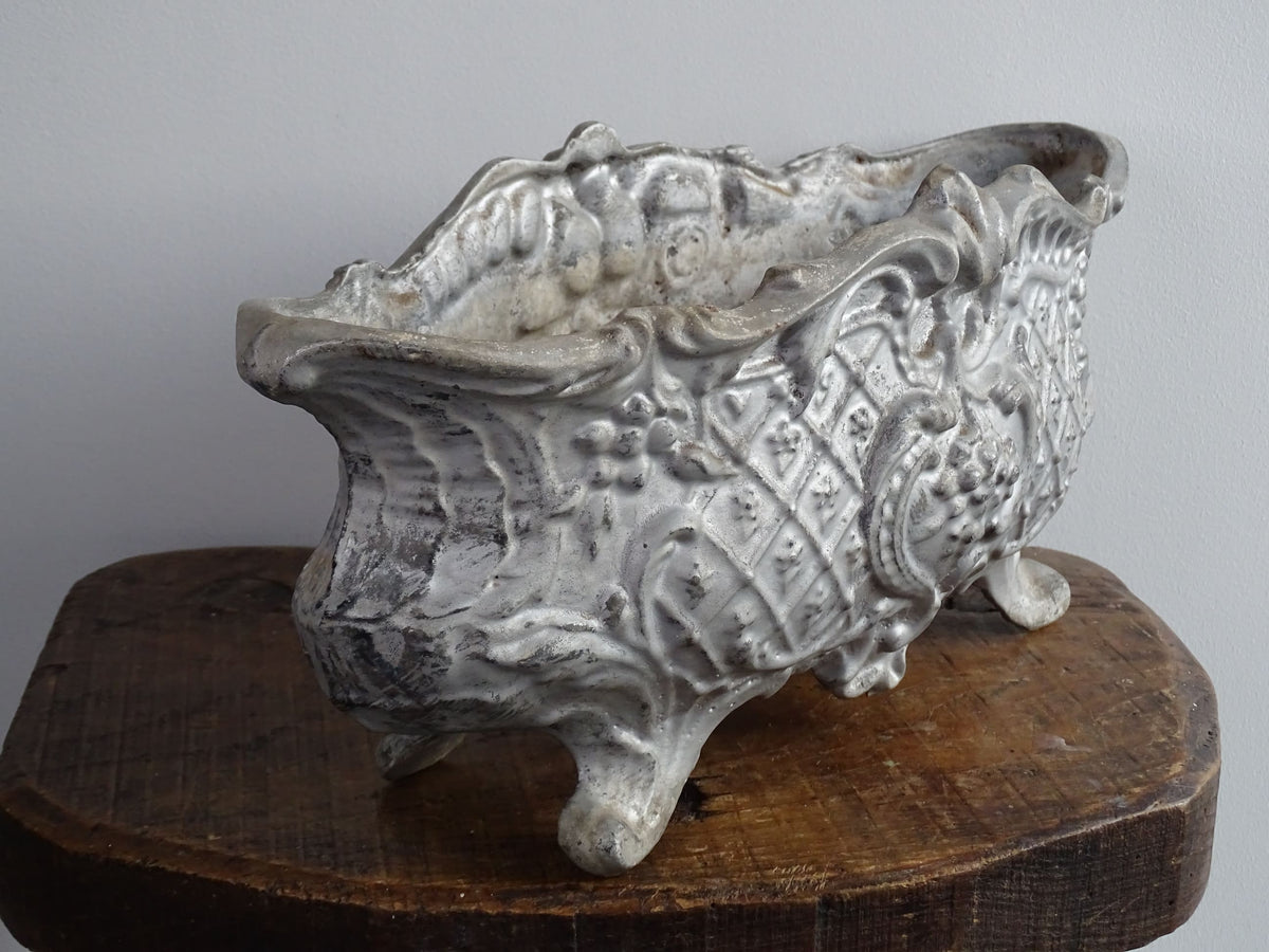 French antique cast iron planter in an oval shape with four ornate feet, painted silver, ideal for indoor or outdoor decor. Antique planter or antique French jardiniere