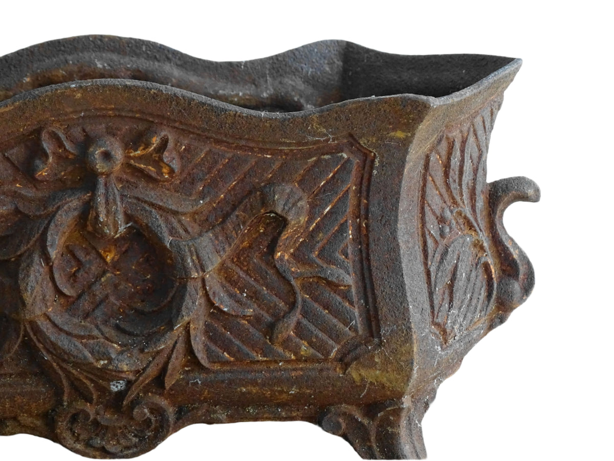 Antique French cast iron jardiniere or antique planter, 19th century, with a gorgeous patina. It is on four feet and has a wreath and ribbon motif decorating it. French outdoor decor.
