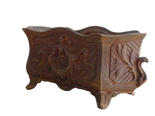 Antique French cast iron jardiniere or antique planter, 19th century, with a gorgeous patina. It is on four feet and has a wreath and ribbon motif decorating it. French outdoor decor.