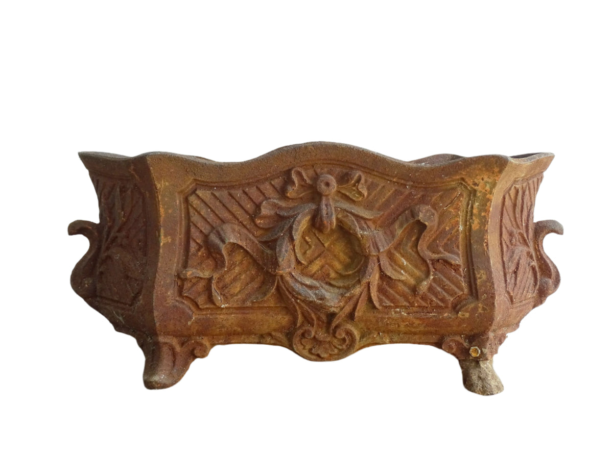 Antique French cast iron jardiniere or antique planter, 19th century, with a gorgeous patina. It is on four feet and has a wreath and ribbon motif decorating it. French outdoor decor.