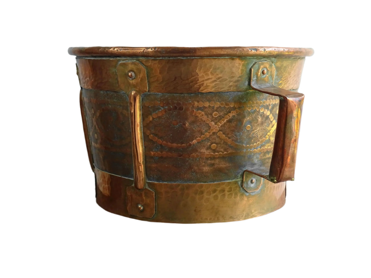 Antique hammered copper bucket from France with aged surface and riveted detail, once used to carry water, shown on a white background.