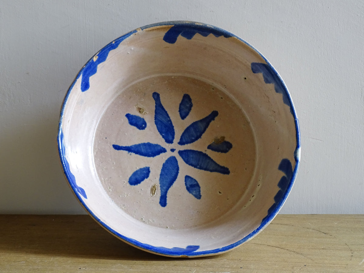 Spanish antique Fajalauza ceramic lebrillo from Granada. Terracotta ottery bowl with a pink tone and hand-painted blue star-shaped flower. Deep bowl for antique wall. Antique Mediterranean decor, decorative bowl.