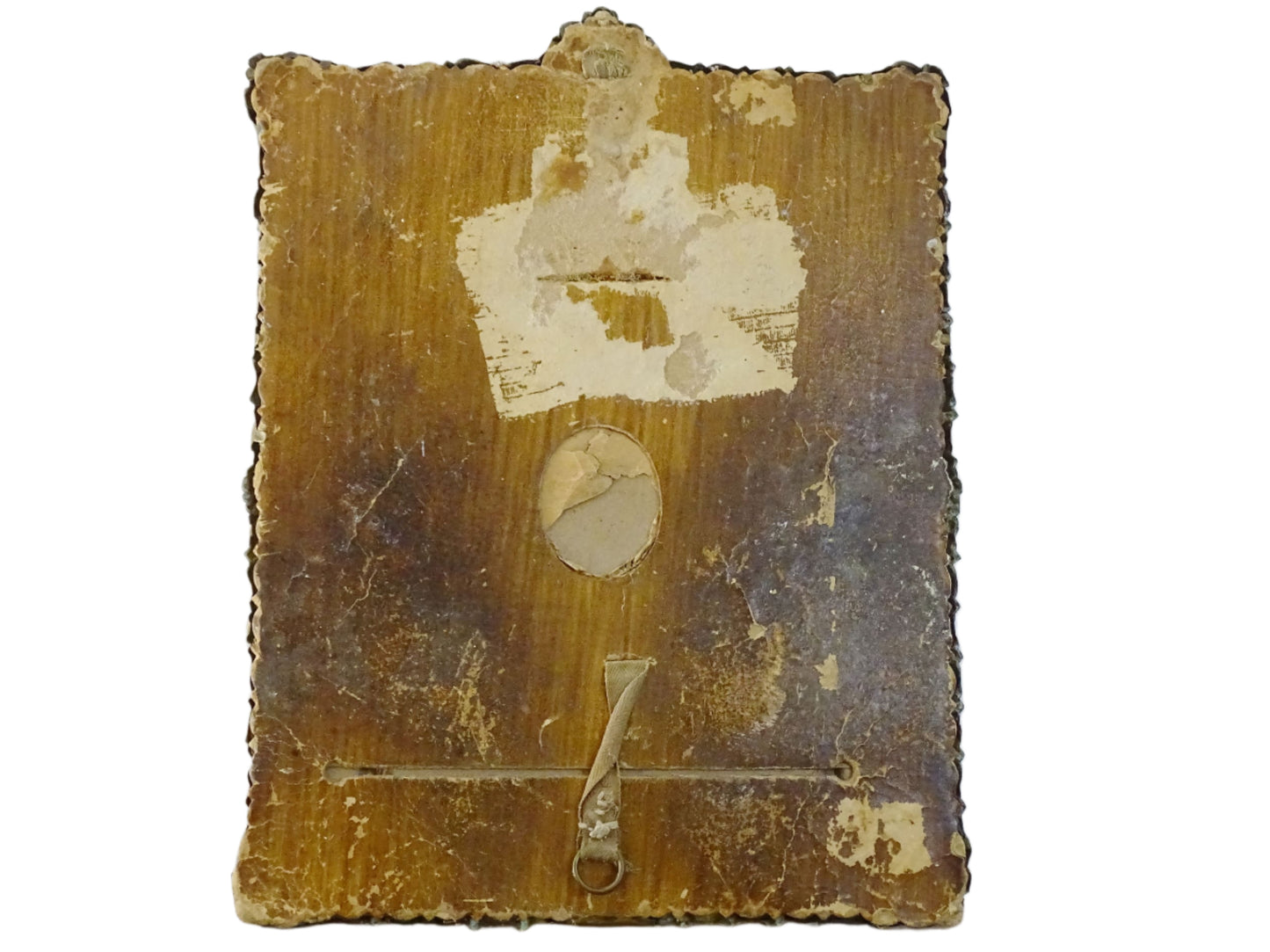 Small French antique brass mirror. The frame is embossed and decorated with a face, flowers and scroll design. Antique French mirror or Foxed mirror.