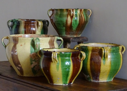 A collection of French antique ceramic planters with green, yellow and brown striped glaze from Castelnaudary.