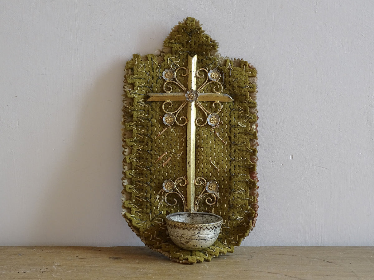 French antique cross with benitier on a stitched felt background, backed by silk. It has small gilt metal flowers adorning the cross and above the basin (benitier). Religious decor for the wall or holy water font.