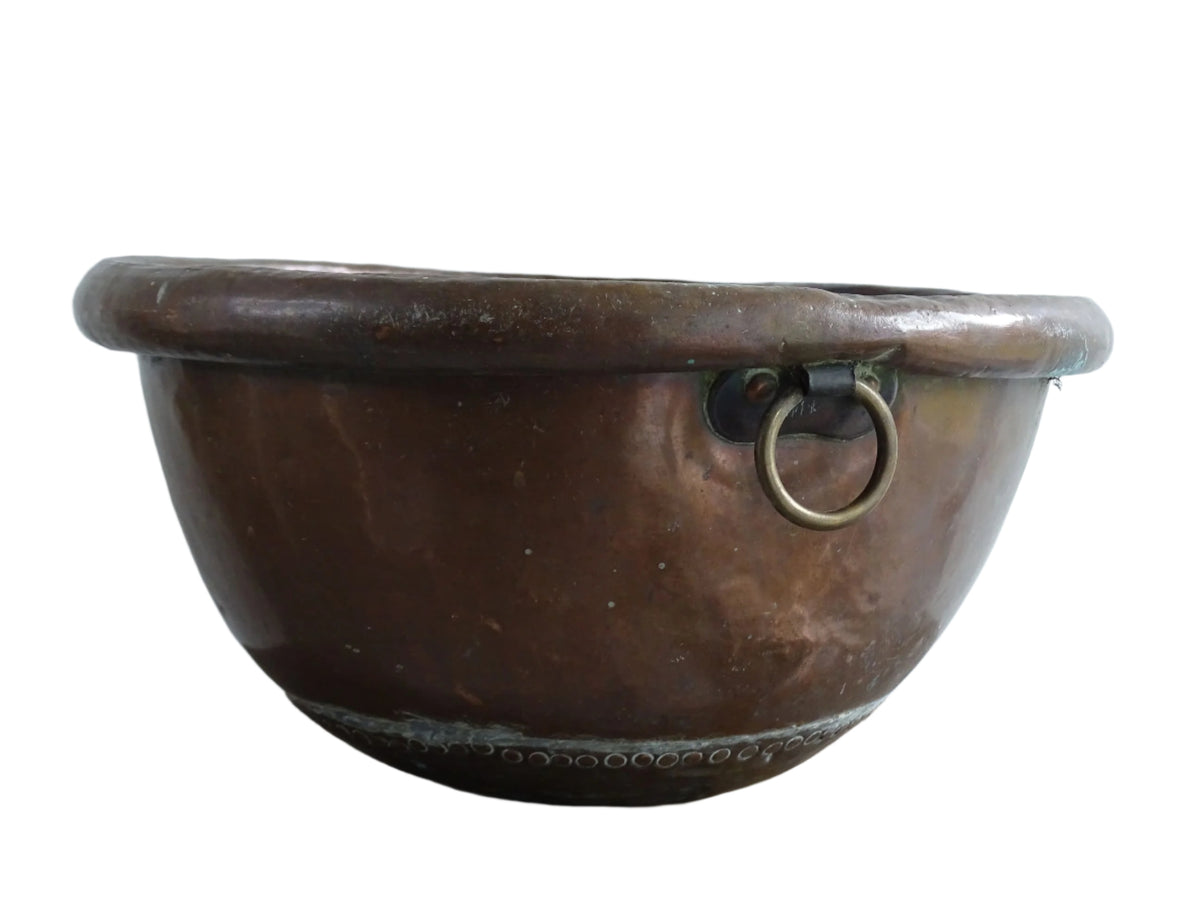 French Antique Copper Bowl for Confectioners 18th C. This timeworn copper mixing bowl has a rolled top and copper rivets to the curved base.
