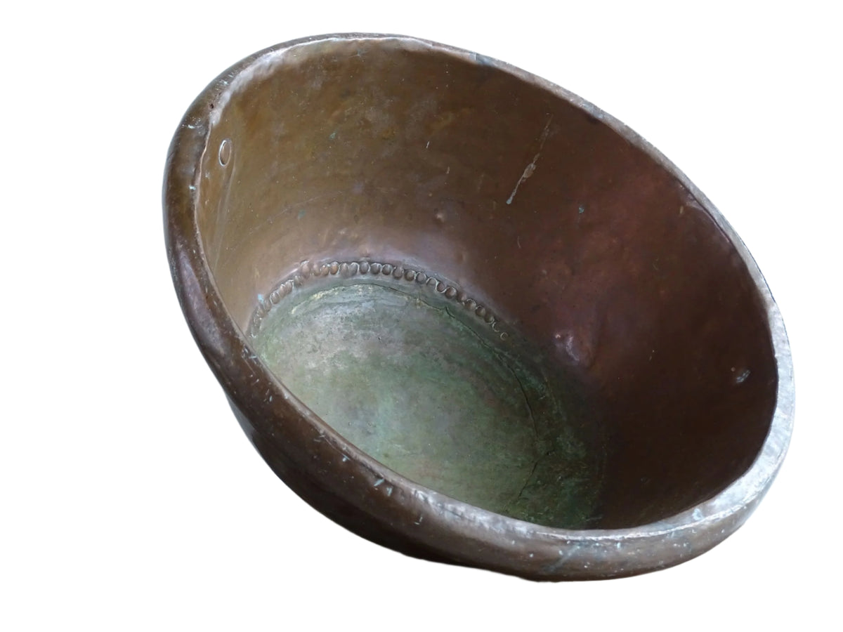French Antique Copper Bowl for Confectioners 18th C. This timeworn copper mixing bowl has a rolled top and copper rivets to the curved base.
