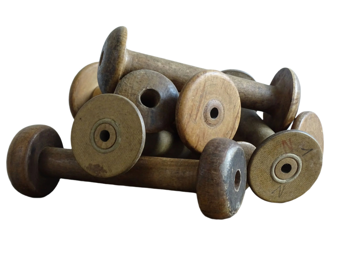 Antique and Vintage Wooden Bobbins with patina. Collection of old wood bobbins for display.