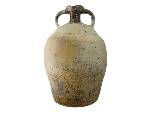 French antique pottery pitcher for a rustic farmhouse kitchen. Earthenware pottery pitcher with brown top, two handles and red-tone body