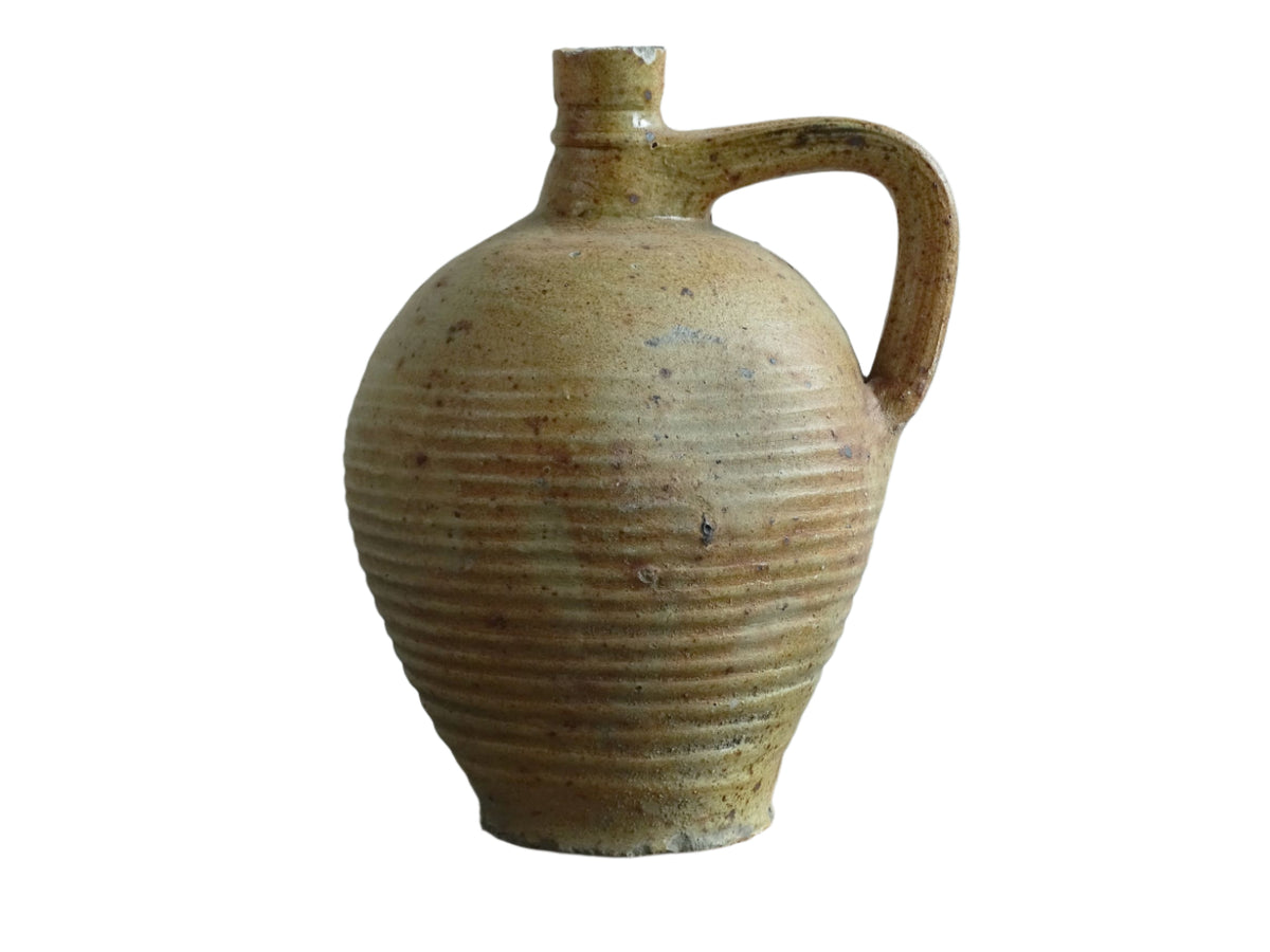 Rustic French antique pottery pitcher with orange and natural tones. Antique pitcher with rich texture for a rustic farmhouse kitchen.