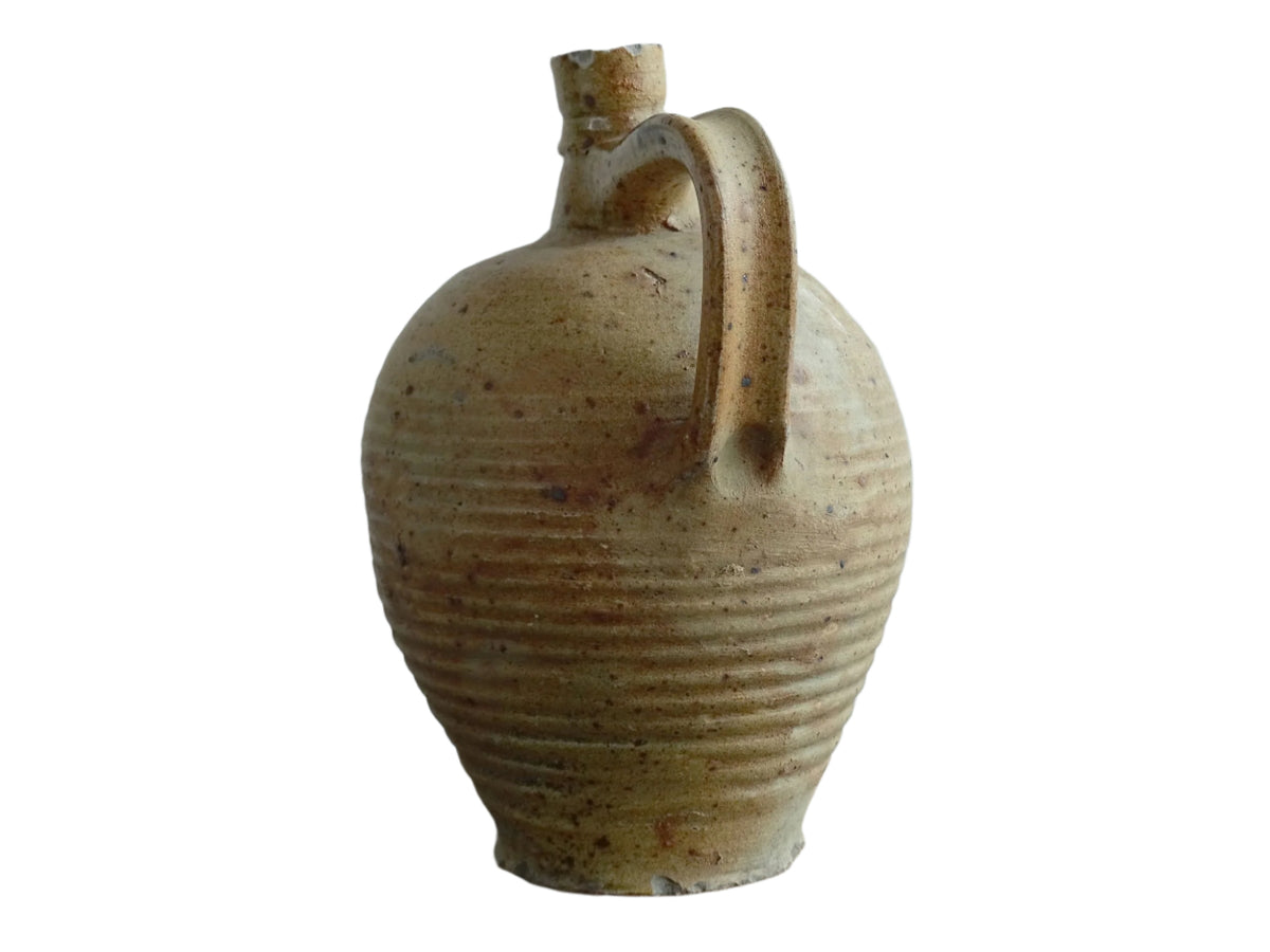 Rustic French antique pottery pitcher with orange and natural tones. Antique pitcher with rich texture for a rustic farmhouse kitchen.