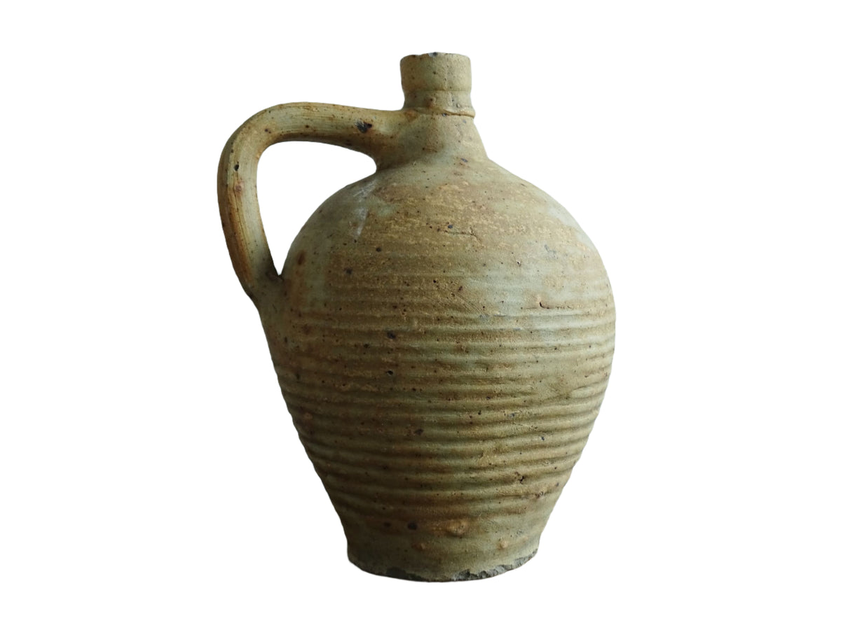 Rustic French antique pottery pitcher with orange and natural tones. Antique pitcher with rich texture for a rustic farmhouse kitchen.