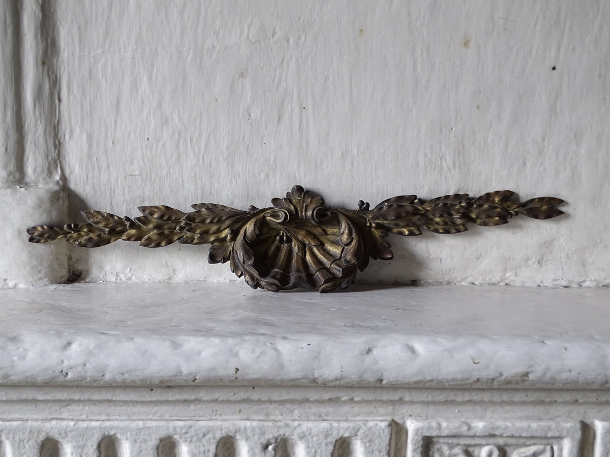 French antique gilt bronze furniture pediment, displayed on a country house fireplace mantel