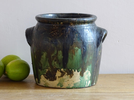 French antique stoneware pot with a green drip paint over earthy base tones. Confit pot for rustic farmhouse decor.