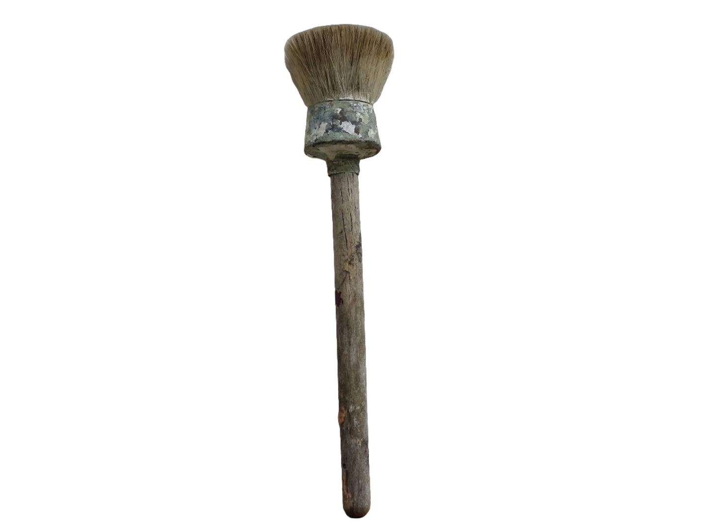 French antique paint brush with horse hair bristles and a wooden handle. The round brush handle still has remnants of paint from use. Art studio decor.