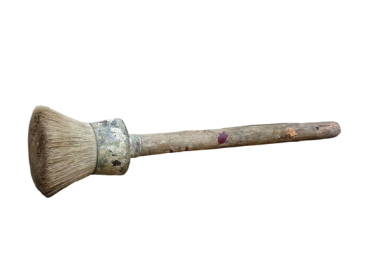 French antique paint brush with horse hair bristles and a wooden handle. The round brush handle still has remnants of paint from use. Art studio decor.