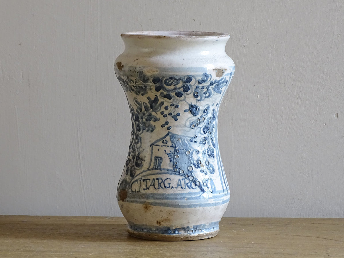 Italian albarello medicine jar from the 18th century, a tin-glazed, blue and white earthenware jar hand-painted with flowers, foliage and a naive house, dated 1763