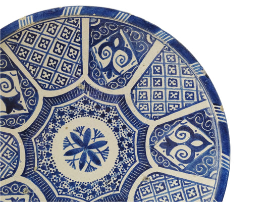 A Moroccan antique blue and white terracotta plate with intricate hand-painted geometric and floral patterns, perfect for Moroccan decor. This decorative plate for wall art or tabletop display showcases traditional pottery craftsmanship with glazed detailing.