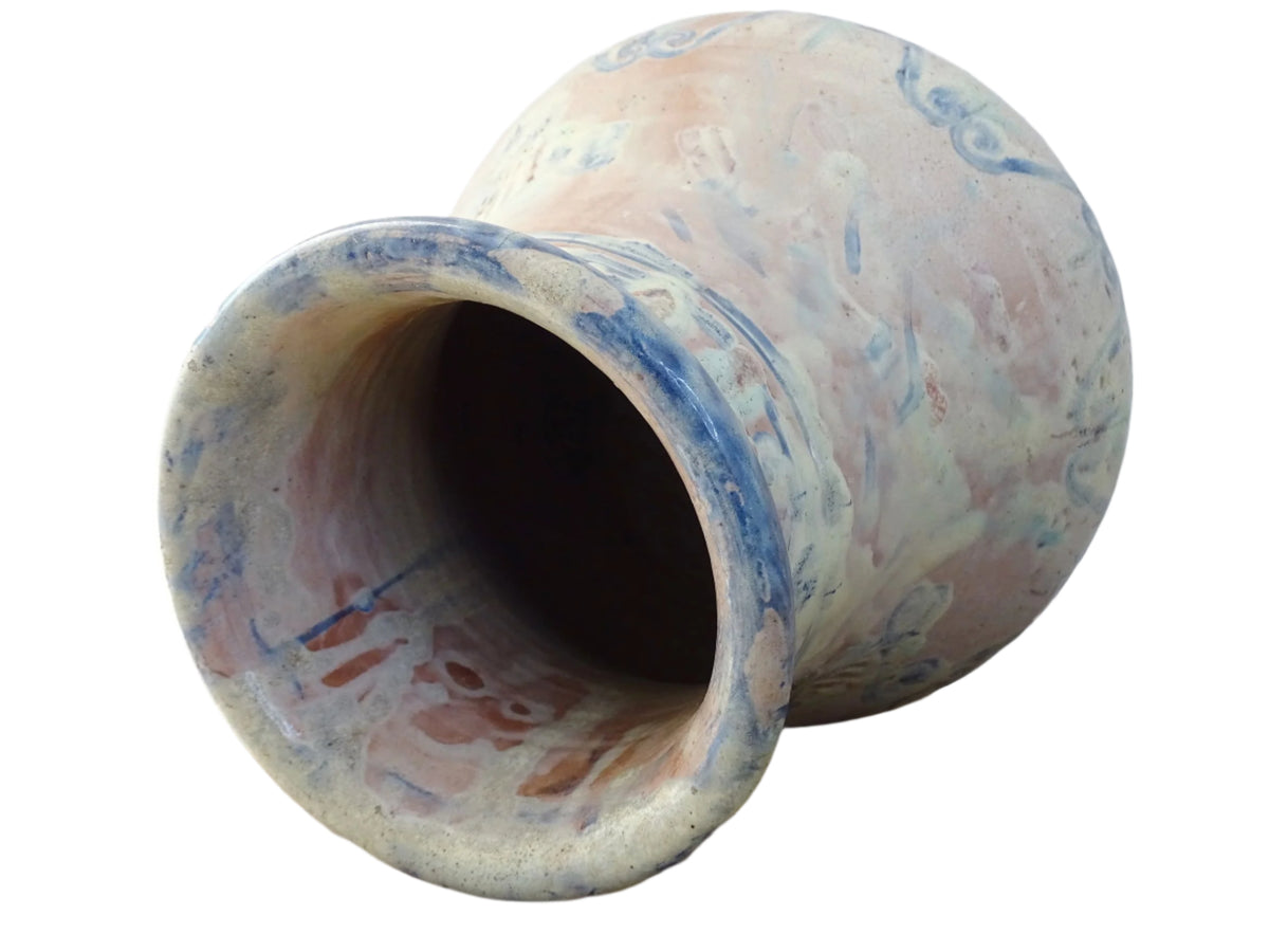 An antique French terracotta baluster vase glazed in soft pink and blue with touches of turquoise. This earthenware vase has a broad lip and a crazed patina.