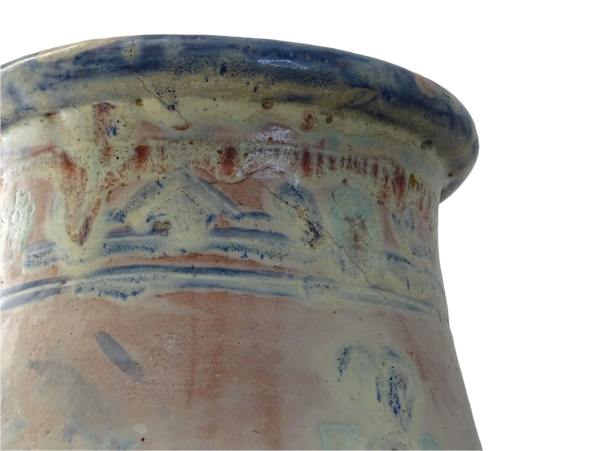 An antique French terracotta baluster vase glazed in soft pink and blue with touches of turquoise. This earthenware vase has a broad lip and a crazed patina.