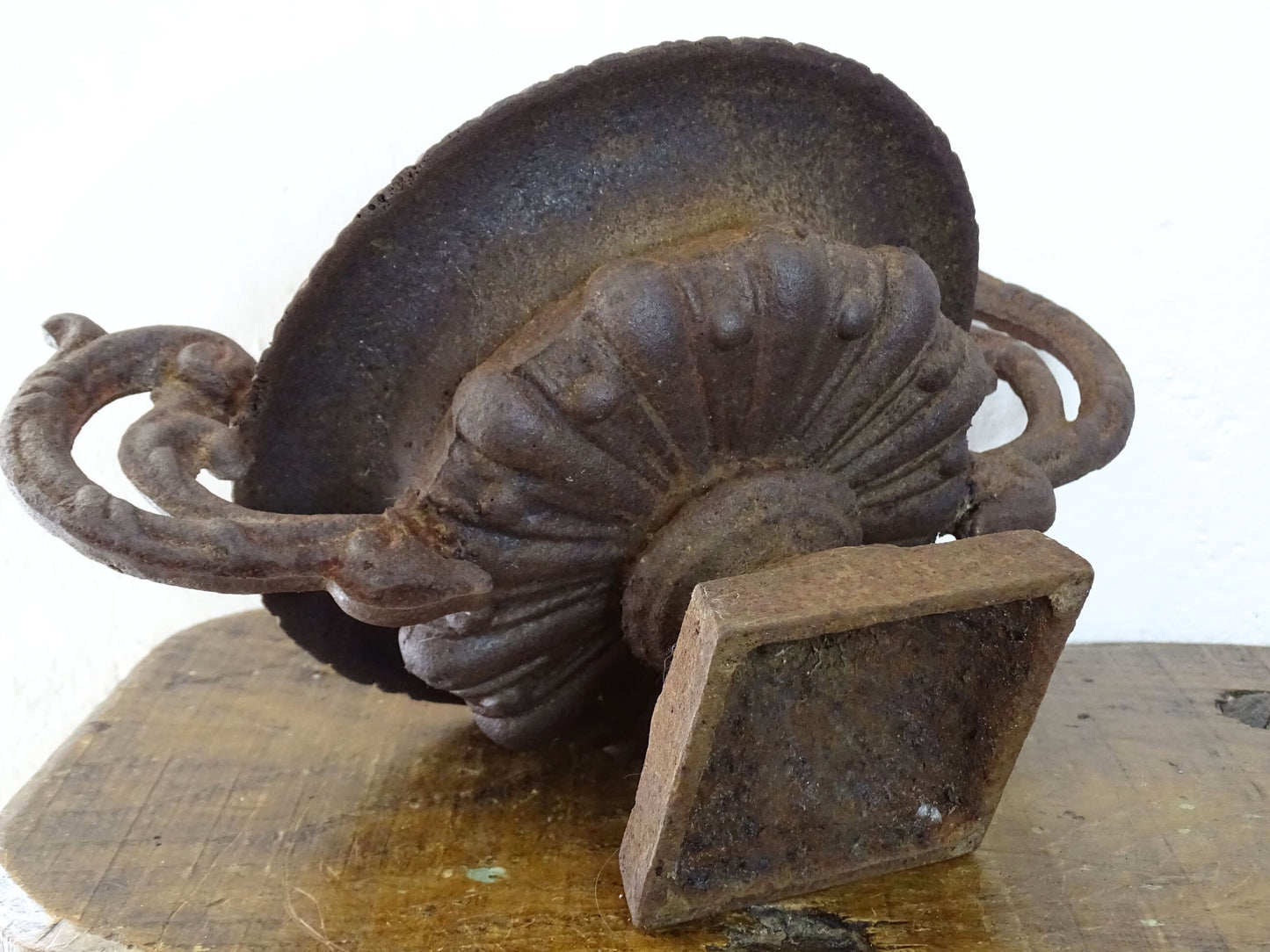 French antique cast iron urn planter with two handles with rusted red tones. Medici urn planter.