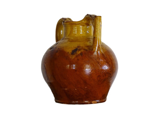 French antique pottery pitcher or orjol with golden caramel and yellow glaze. Antique terracotta cruche or jug with timeworn appearance.
