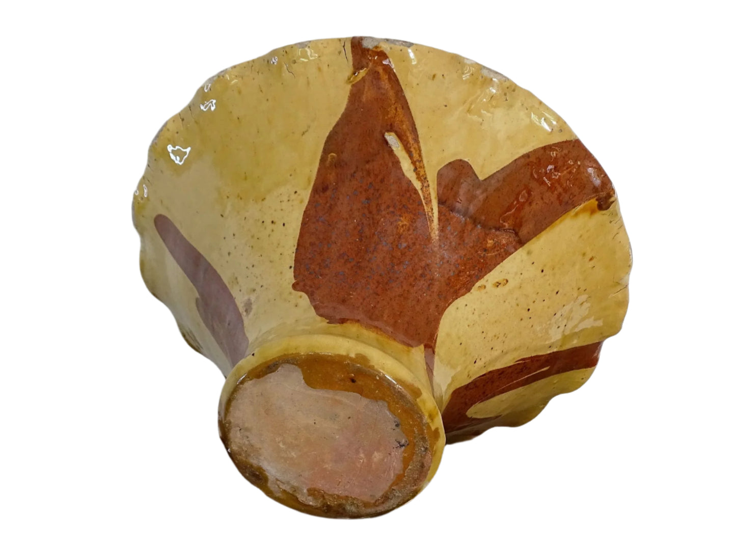 French antique terracotta bowl with yellow glaze, this earthenware basin has sweeps of a red-brown tone to the body and a crimped, pie crust style edge.