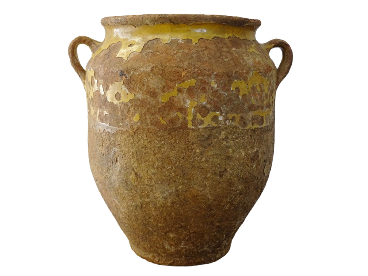 Antique French confit pot with yellow glaze, a large rustic terracotta pot or confit jar from the South of France.