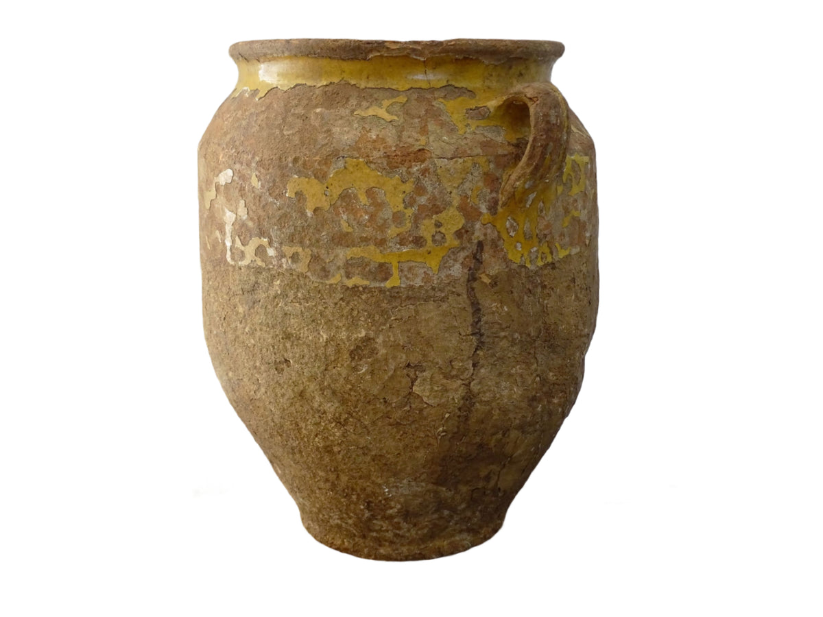 Antique French confit pot with yellow glaze, a large rustic terracotta pot or confit jar from the South of France.