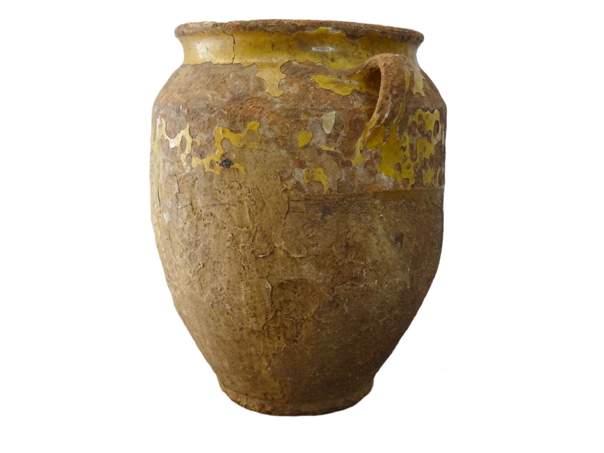 Antique French confit pot with yellow glaze, a large rustic terracotta pot or confit jar from the South of France.