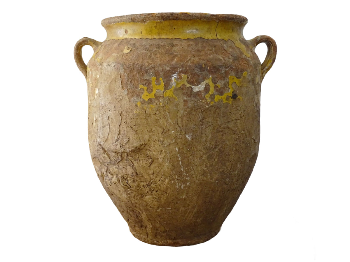 Antique French confit pot with yellow glaze, a large rustic terracotta pot or confit jar from the South of France.